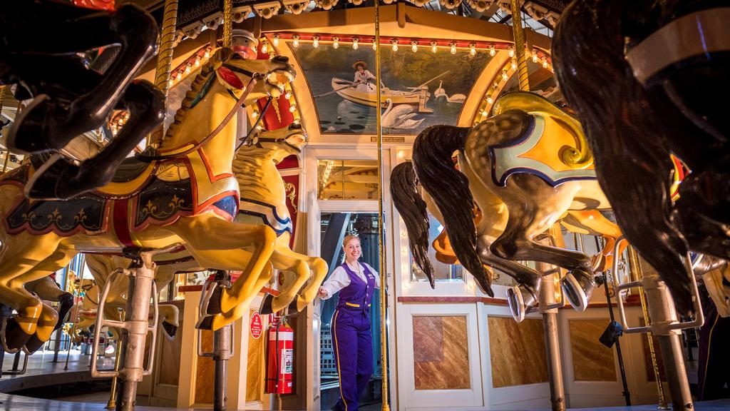 Luna Park ride operator Ola Koch shows off the carousel and its motor area, which are part of this year’s Open House Melbourne program. Picture: Jake Nowakowski
