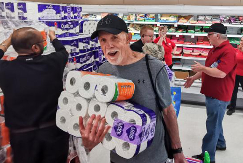 Toilet paper was in short supply in many places in Australia in March. This happy-looking shopper in Sydney got lucky. Picture: AAP

