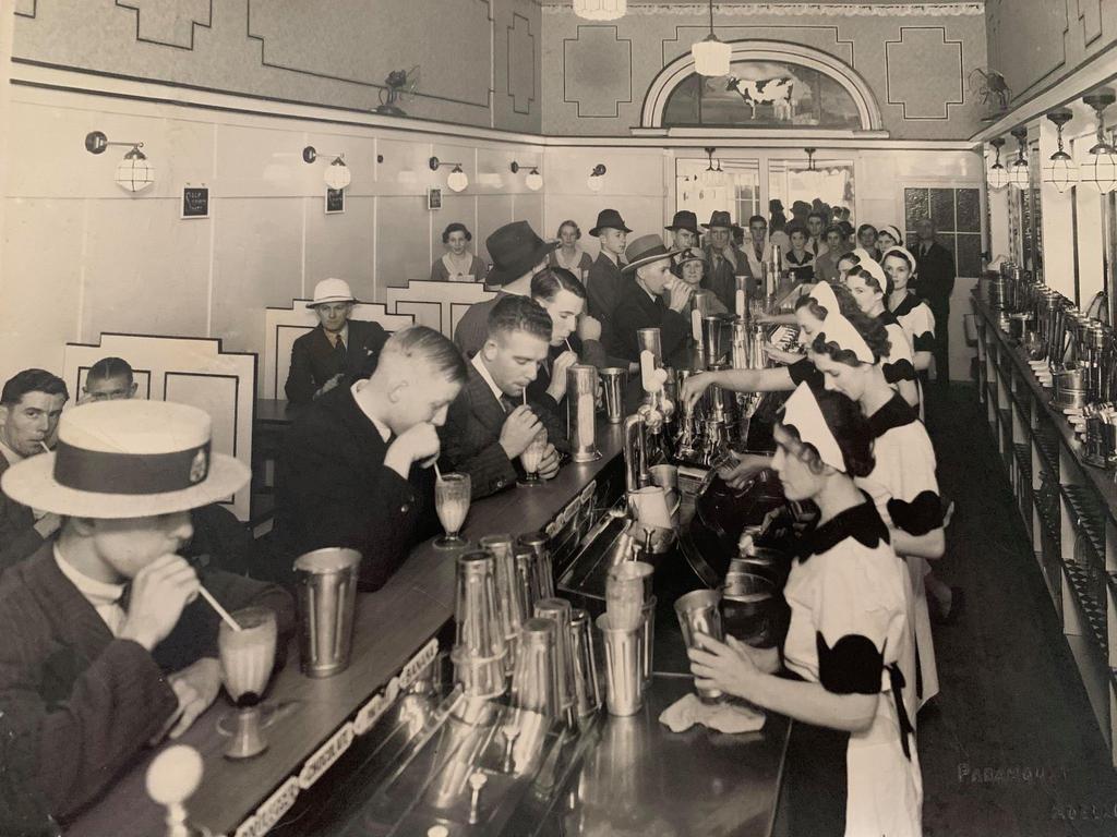 Supplied Editorial Staff, including Thelma Watt (nee Richards), far right, looking at the camera, serve customers in Adelaide's Black and White Milk Bar, in King William Street, in 1936. The photo is stamped Paramount Adelaide in the bottom right corner. Source: supplied by Allison Aldam