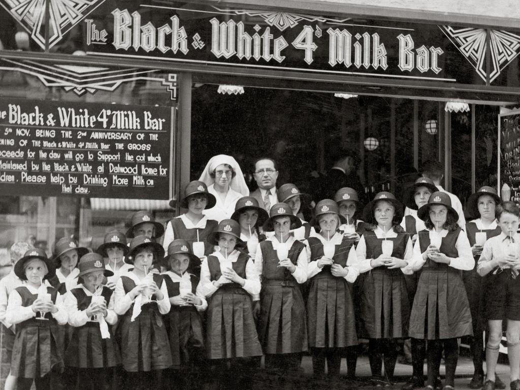 Black & White 4d. Milk Bar � exterior Martin Place, Sydney, NSW, 1934 Mick Adams is standing in the centre, at the back of the group of children. Photo courtesy L. Keldoulis, from the In Their Own Image: Greek-Australians National Project Archives