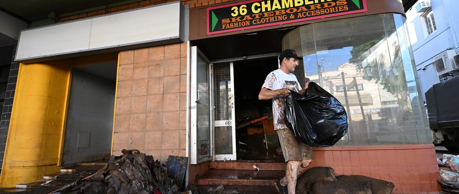 Travis Watson throws away flood damaged merchandise from his skate shop in Lismore. Picture: Getty
