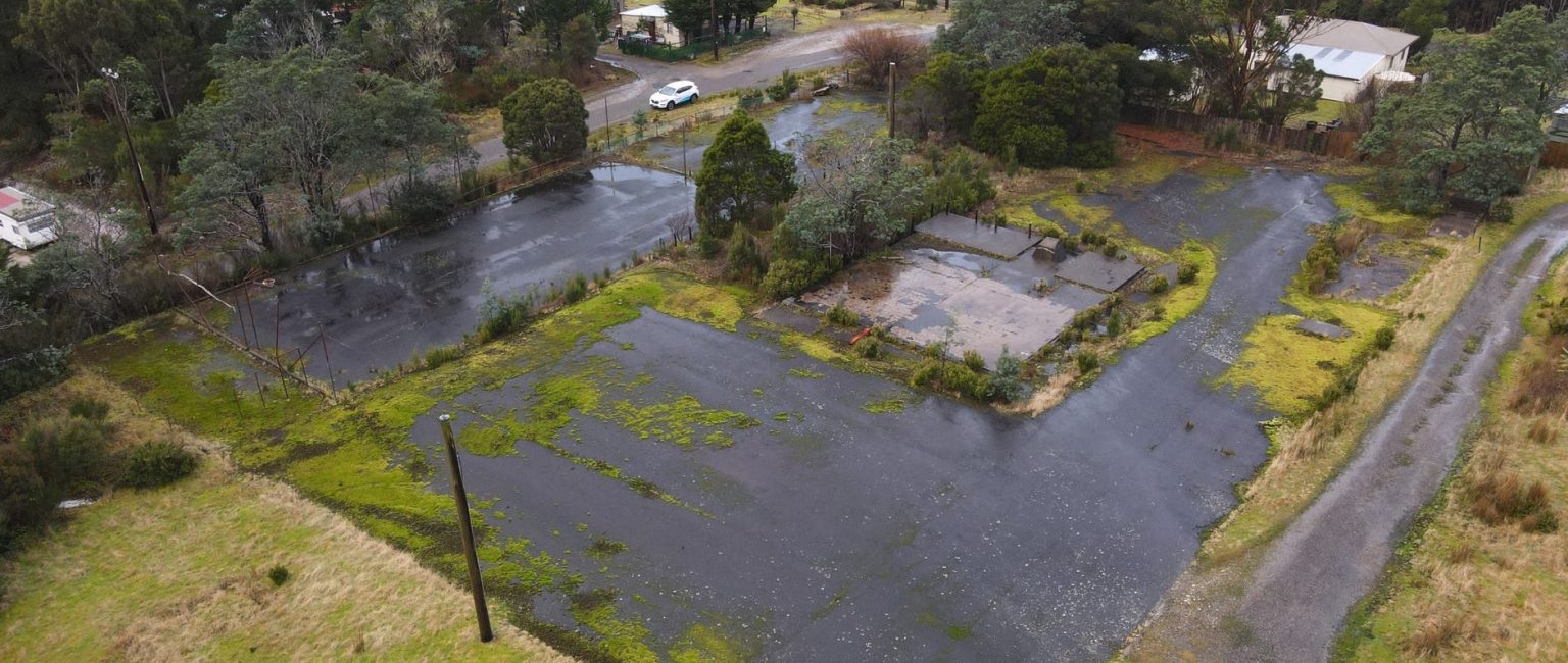 An eerie vacant lot in a Tasmanian ghost town has hit the market for just $115,000.
