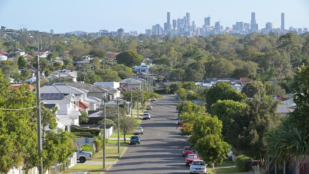 Residential houses street against Brisbane City skyline in Queensland Australia