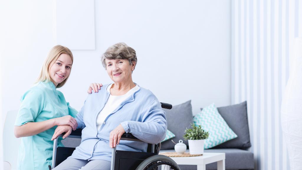 Elderly woman and caregiver