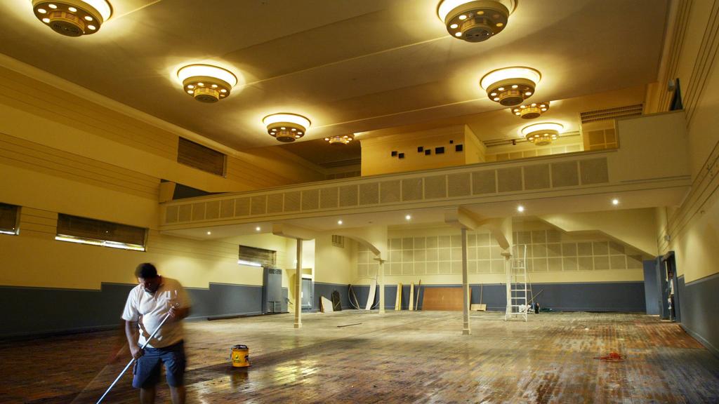 Worker Abdel Danial mops the floors of The Hub Theatre at Newtown in Sydney, has been refurbished as venue for the up-coming Cracker Comedy Festival.