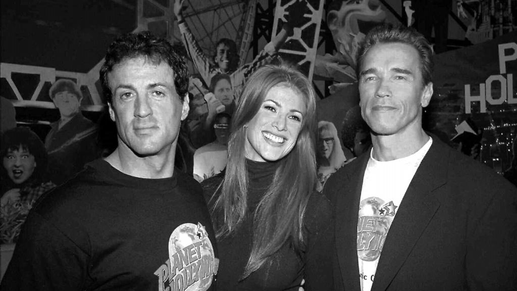 (L-R) Actor Sylvester Stallone, model Angie Everhart & actor Arnold Schwarzenegger at opening party at Planet Hollywood in Atlantic City, New Jersey 22/04/95 Stallone & Schwarzenegger, principal shareholders in restaurant. Entertainment / With Others General